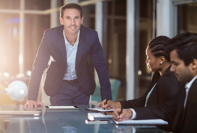 Portrait of businessman with coworkers in a meeting in the conference room